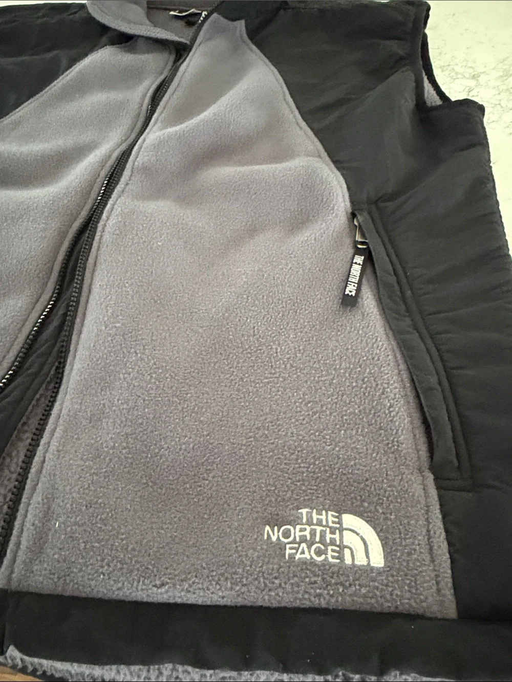 The North Face Black Shell with Gray Fleece-Lined Men's Vest